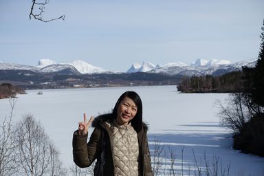 Suzanne in front of Solöyvatnet. Apparently there's Arctic char in there. Mountains of Sjunkhatten national park in the background. (2015:04:11)